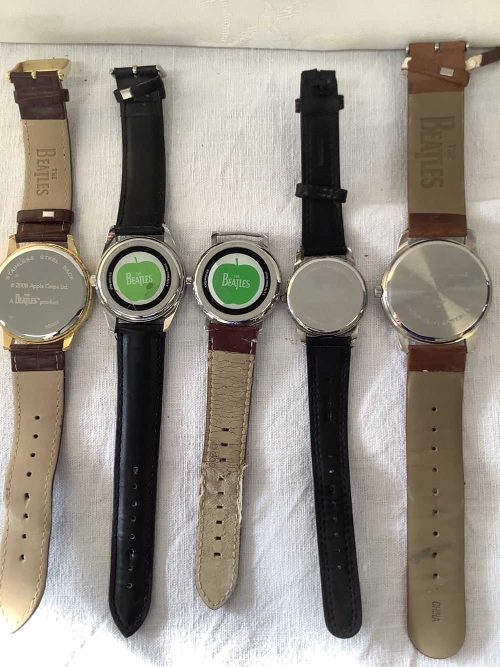 5 montres de collection, The Beatles, marque Apple, 2 bracelets en mauvais état, datée de 1996 à 2011, en l’état, accidents. 2 monnaies 5 montres de collection the beatles marque apple 2 bracelets en mauvais etat datee de 1996 a 2011 en l etat accidents