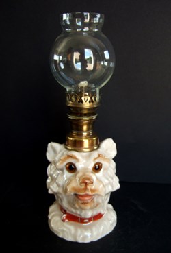 Lampe zoomorphe à pétrole figurant une tête de chien.