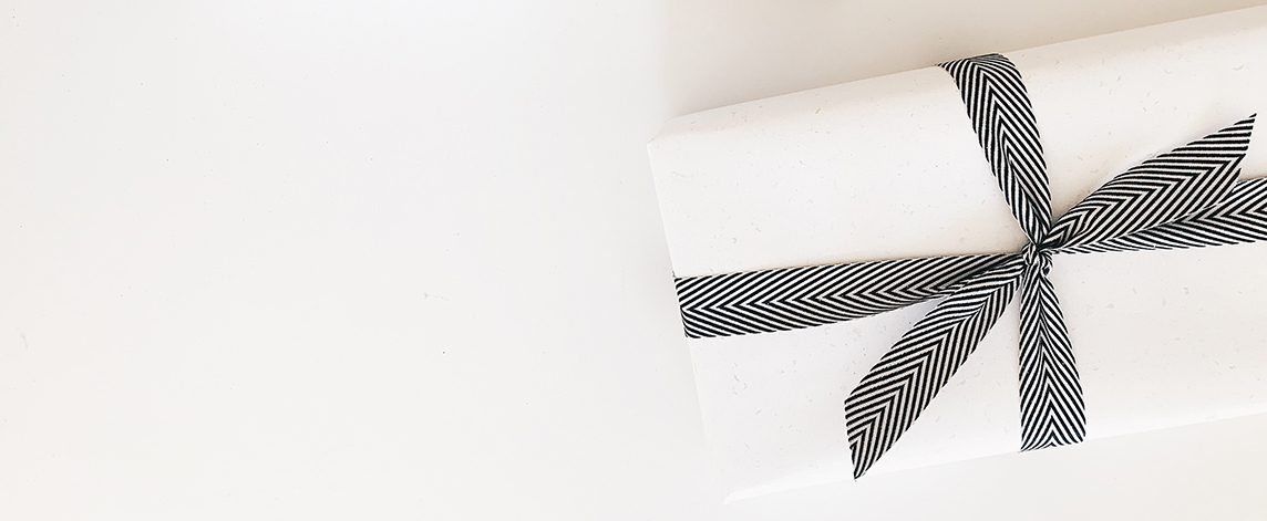 White wrapped gift in a white table